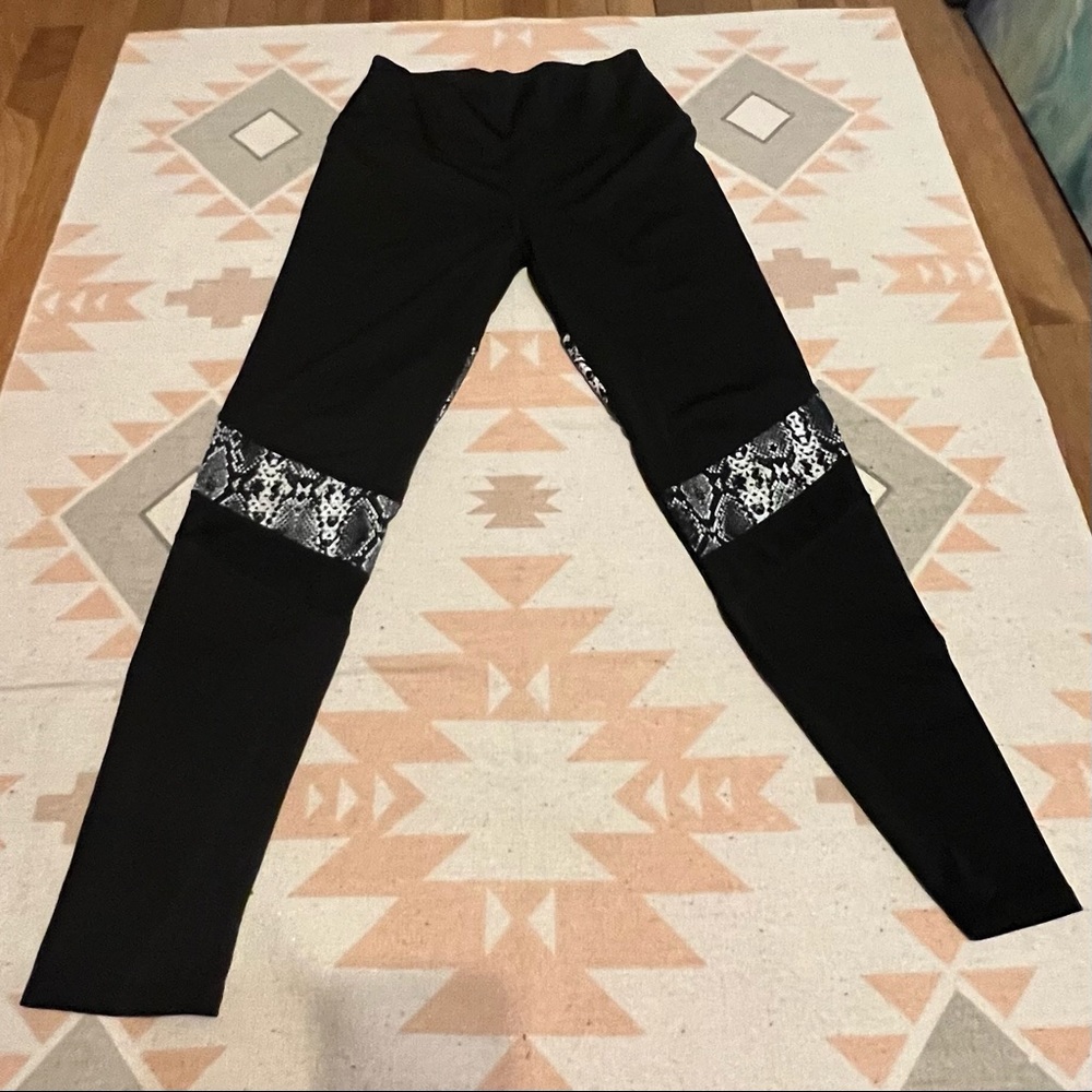 Black leggings with snakeskin and mesh strips
